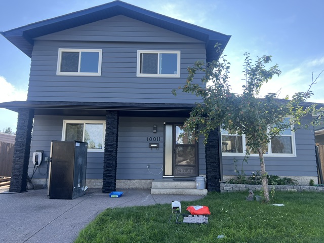 Siding repainted blue with dark accents