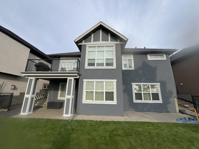 Stucco home repainted grey with white trim