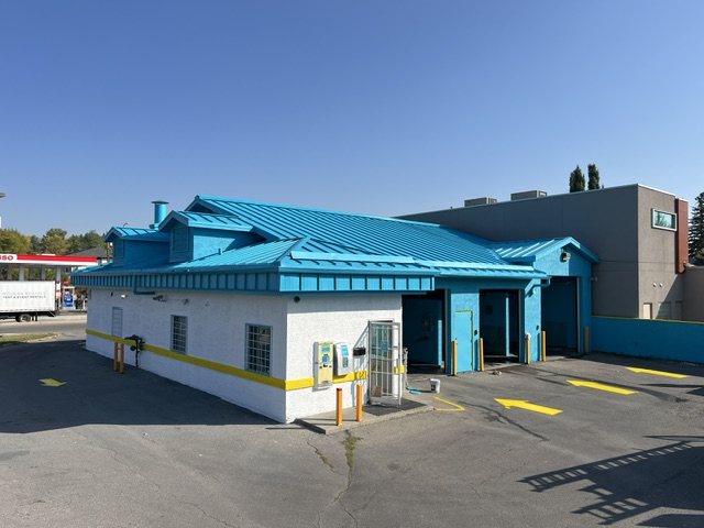 Commercial building exterior finished in white with yellow trim