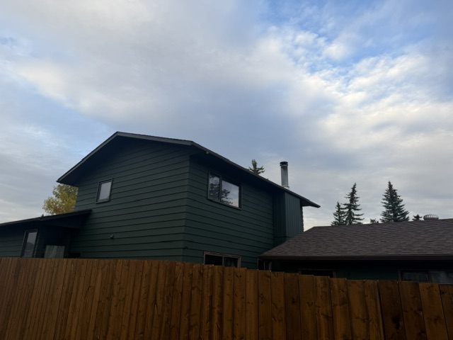 House and garage siding repainted dark green